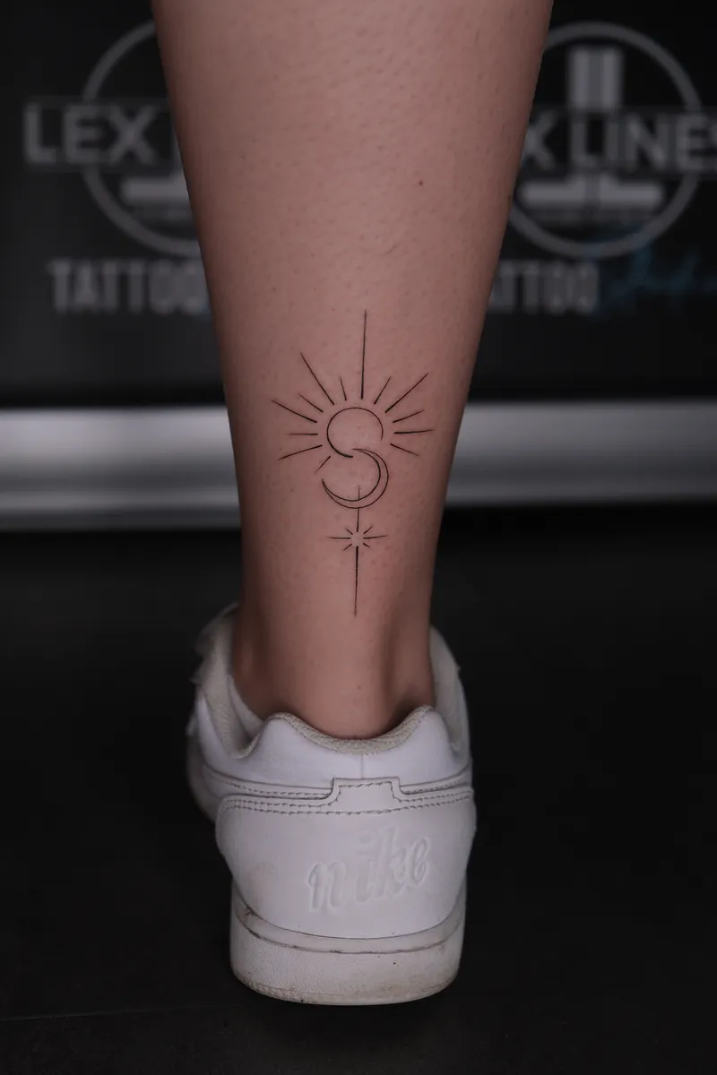 Feines Sonnen- und Mondtattoo am Knöchel