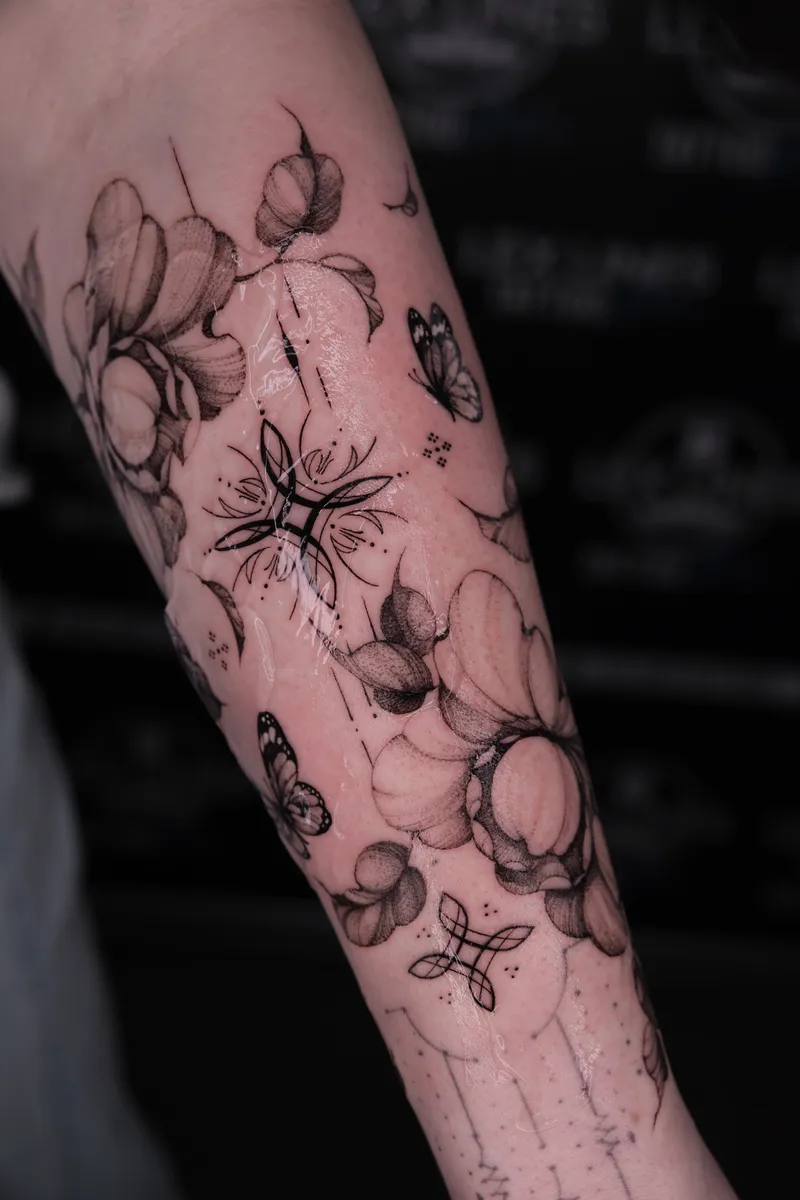Florales Unterarm-Tattoo mit feinen Ornamenten